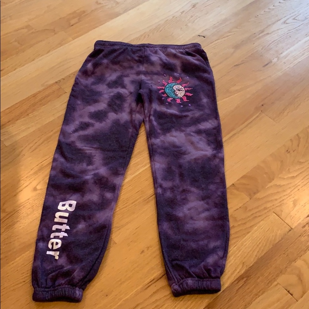 purple sweatpants with a sun